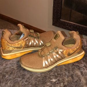 Nike women’s shox gravity; metallic gold, floral